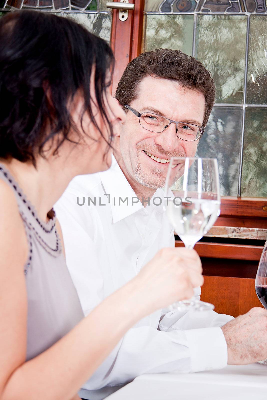 smiling happy people in restaurant drinking talking having fun 