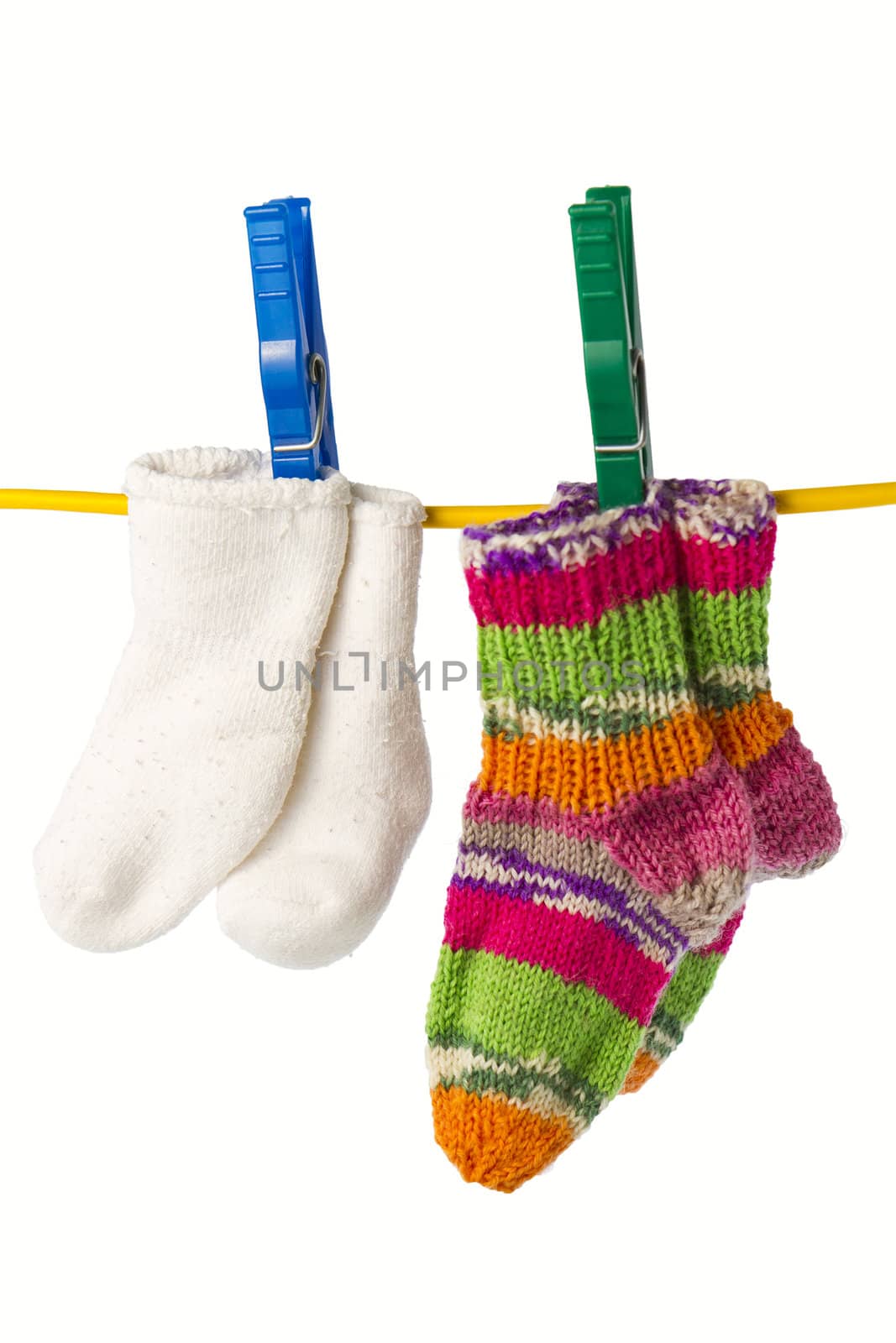 four baby socks on yellow clothesline with clothespin in white background