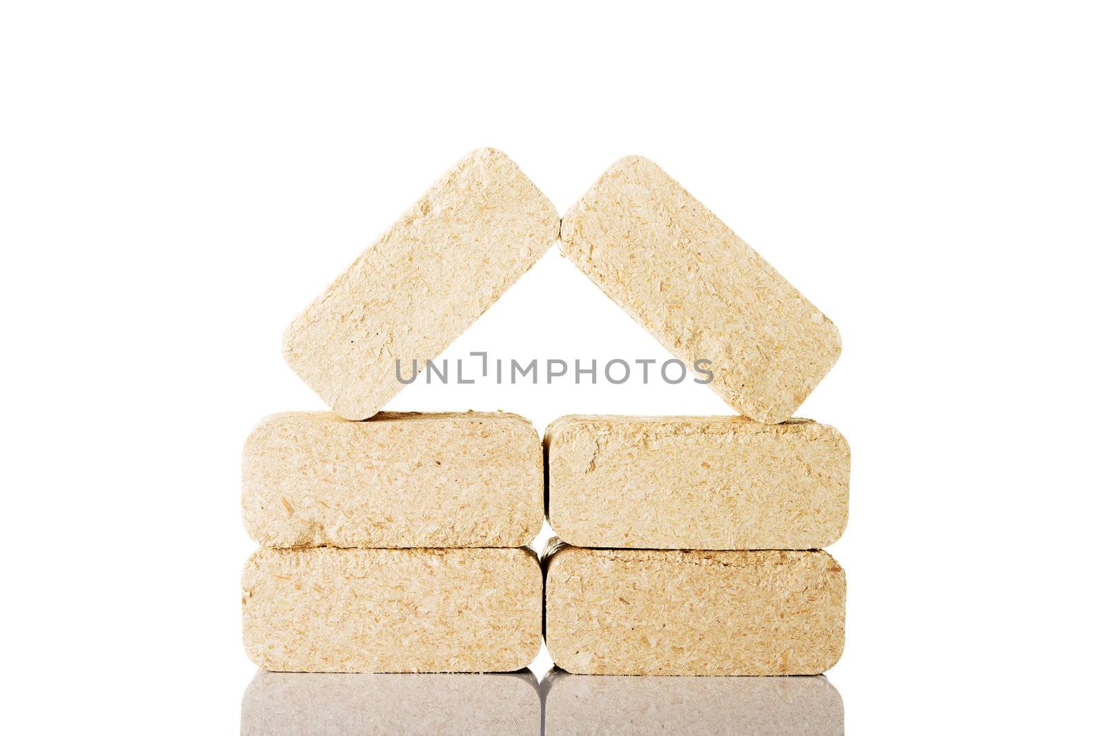 Wood sawdust briquettes , isolated on white