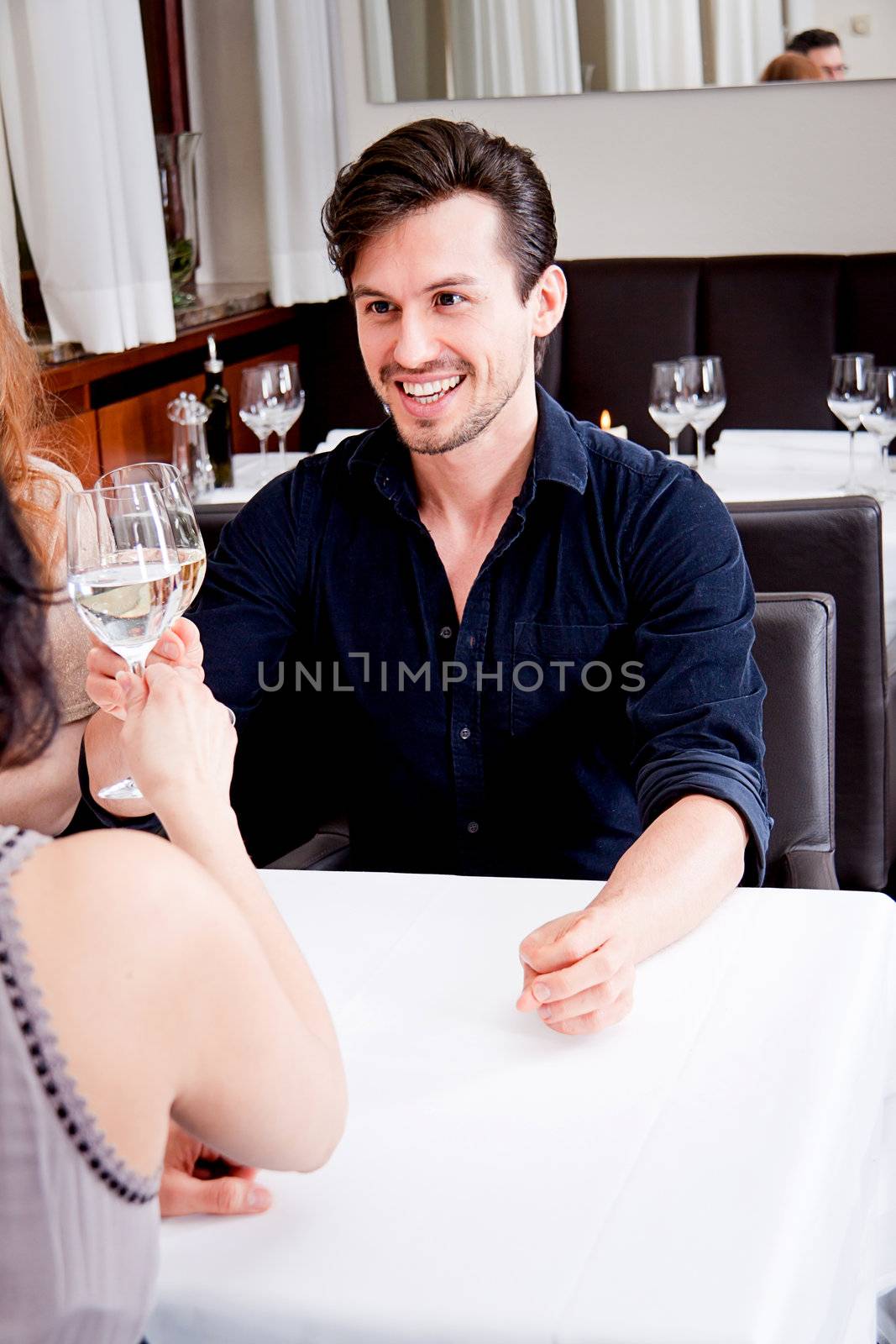 smiling happy people in restaurant drinking talking having fun 