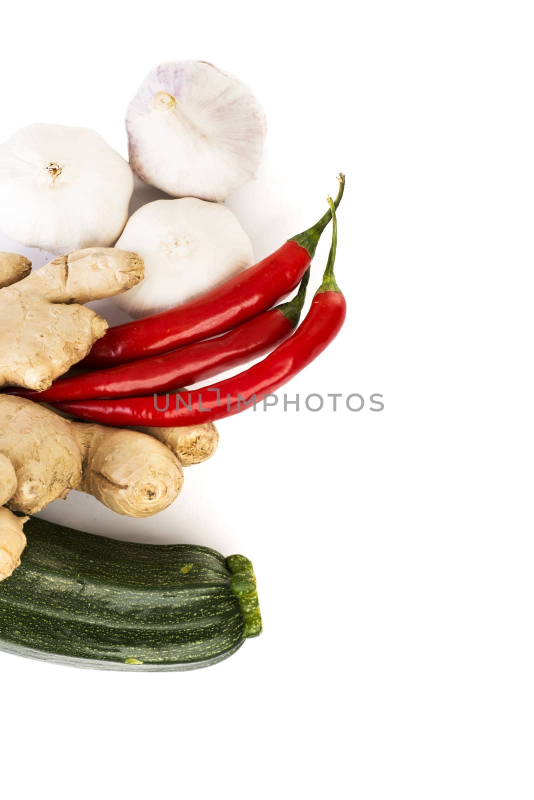 Zucchini, imbir,garlic and red hot chilie peppers over white background. Group of vegetables.