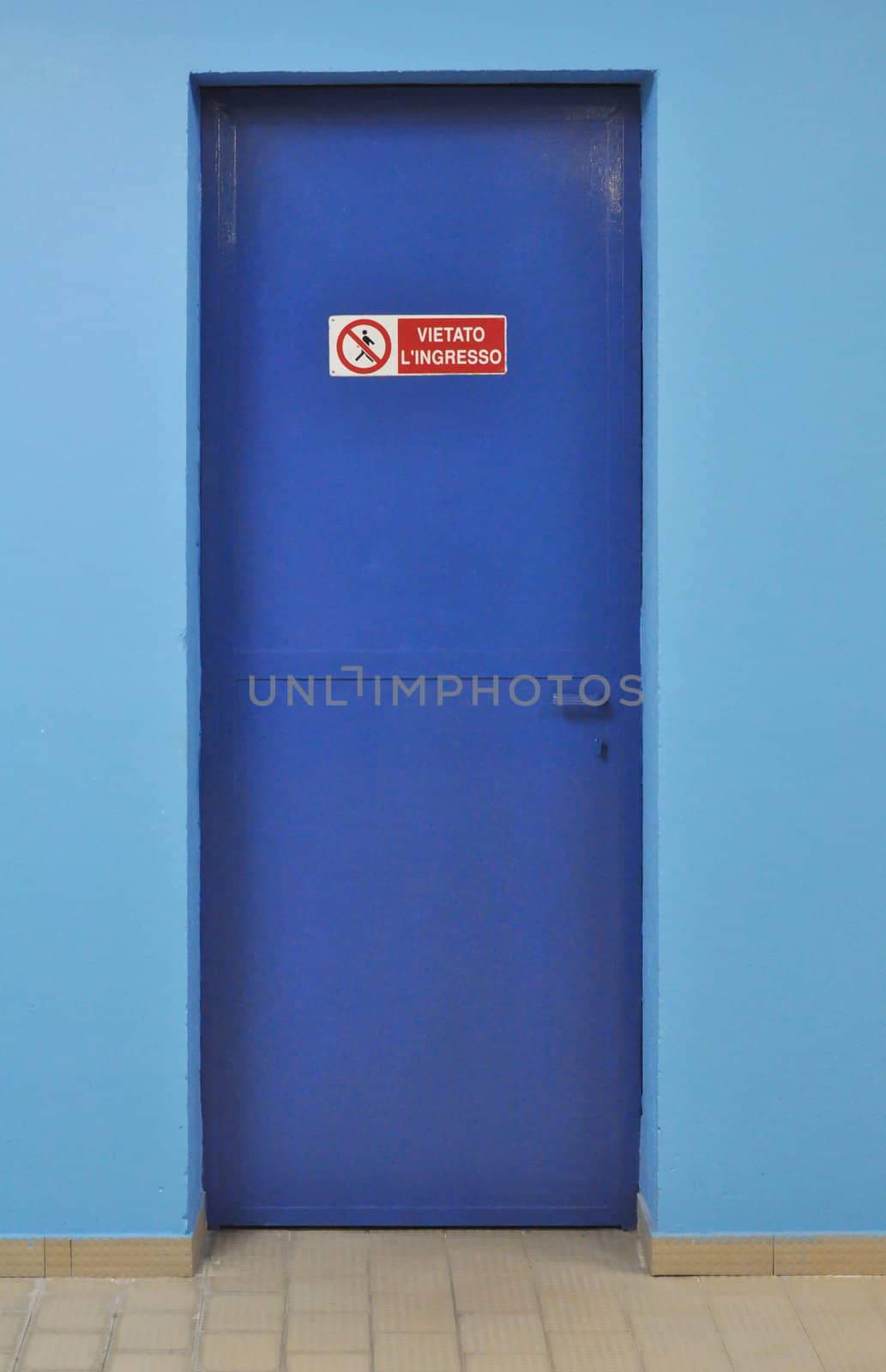 No entry sign on a blue firewall door - in Italian