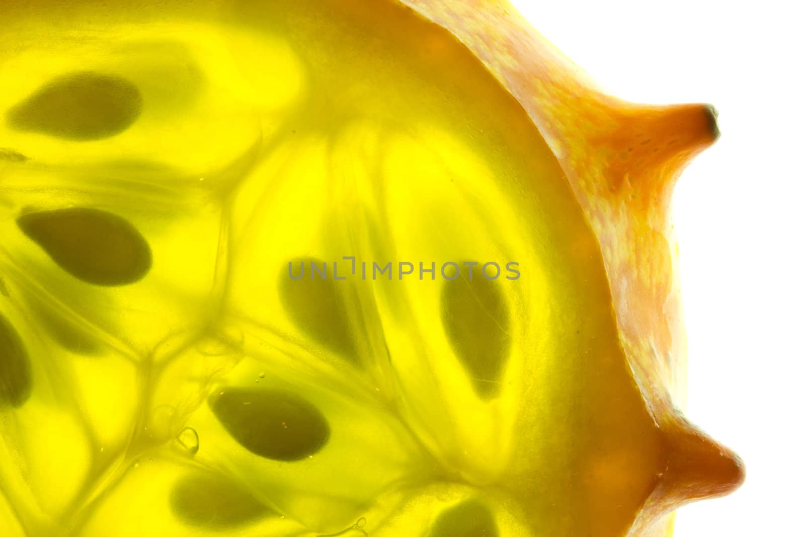 Close-up image of a slice of a kiwano melon on a white background