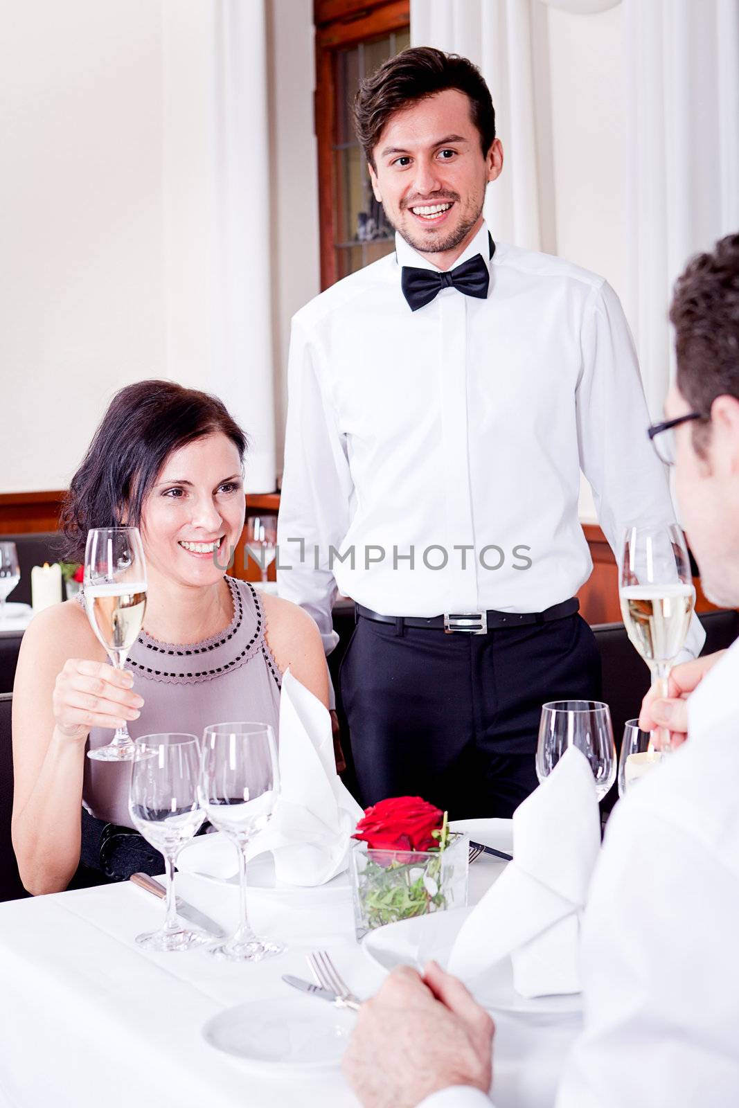 happy smiling couple in restaurant by juniart