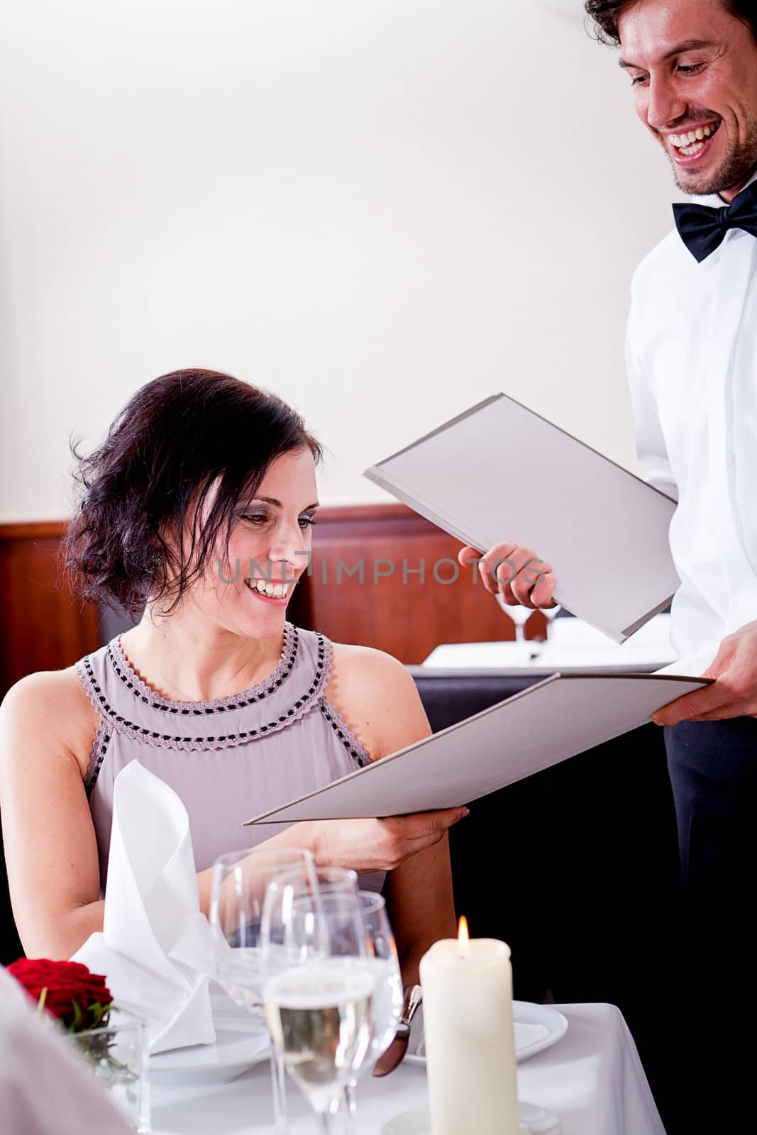 man and woman in restaurant waiter bring card and order food