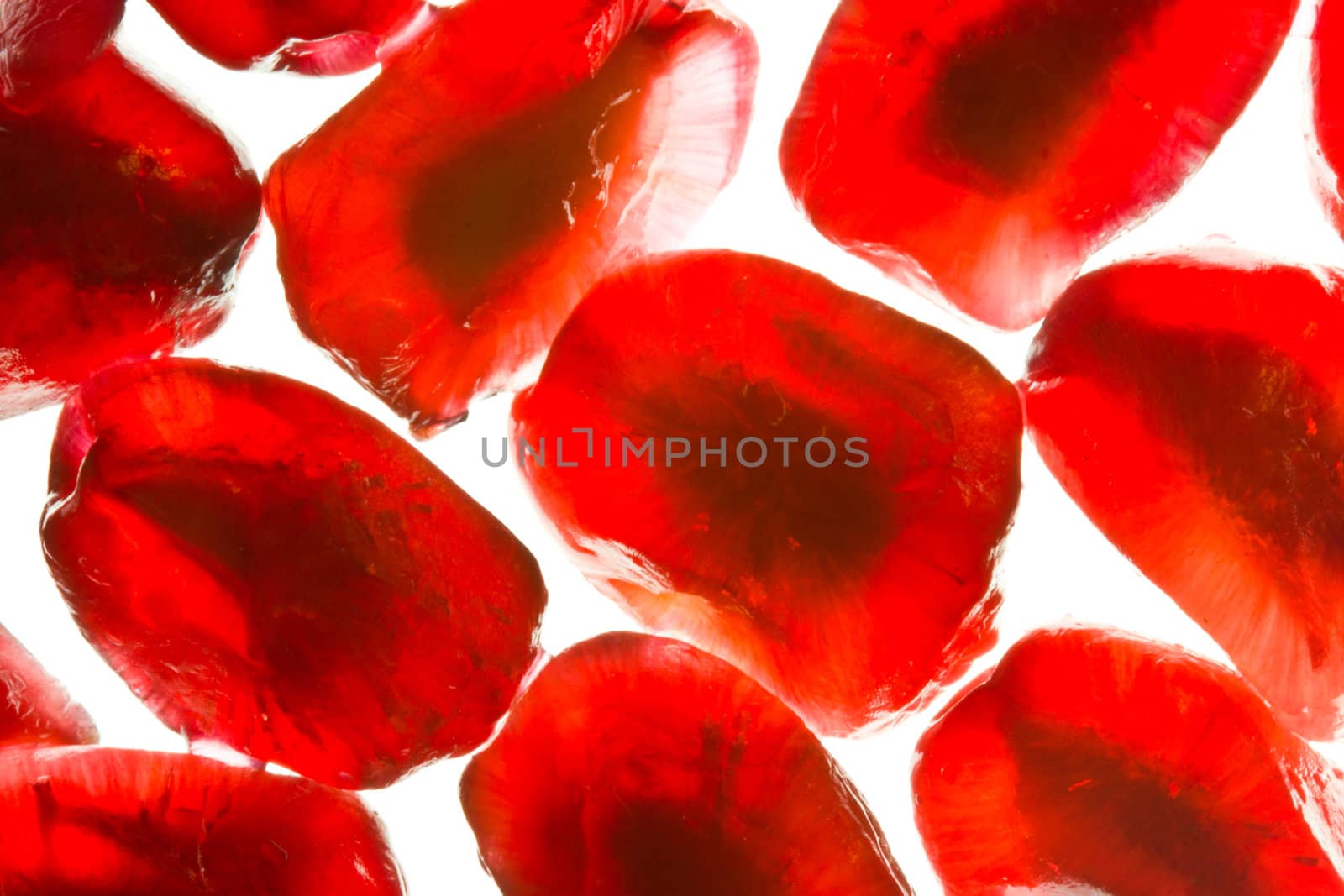 Close-up image of pomegranate seeds on a white background