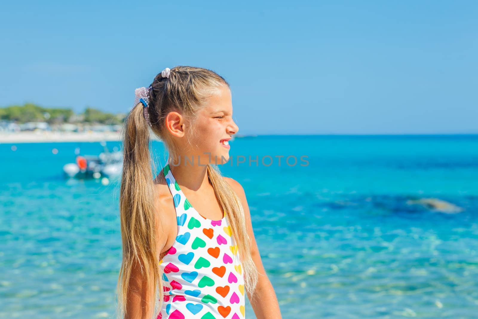 Portrait of cute happy girl on the beach