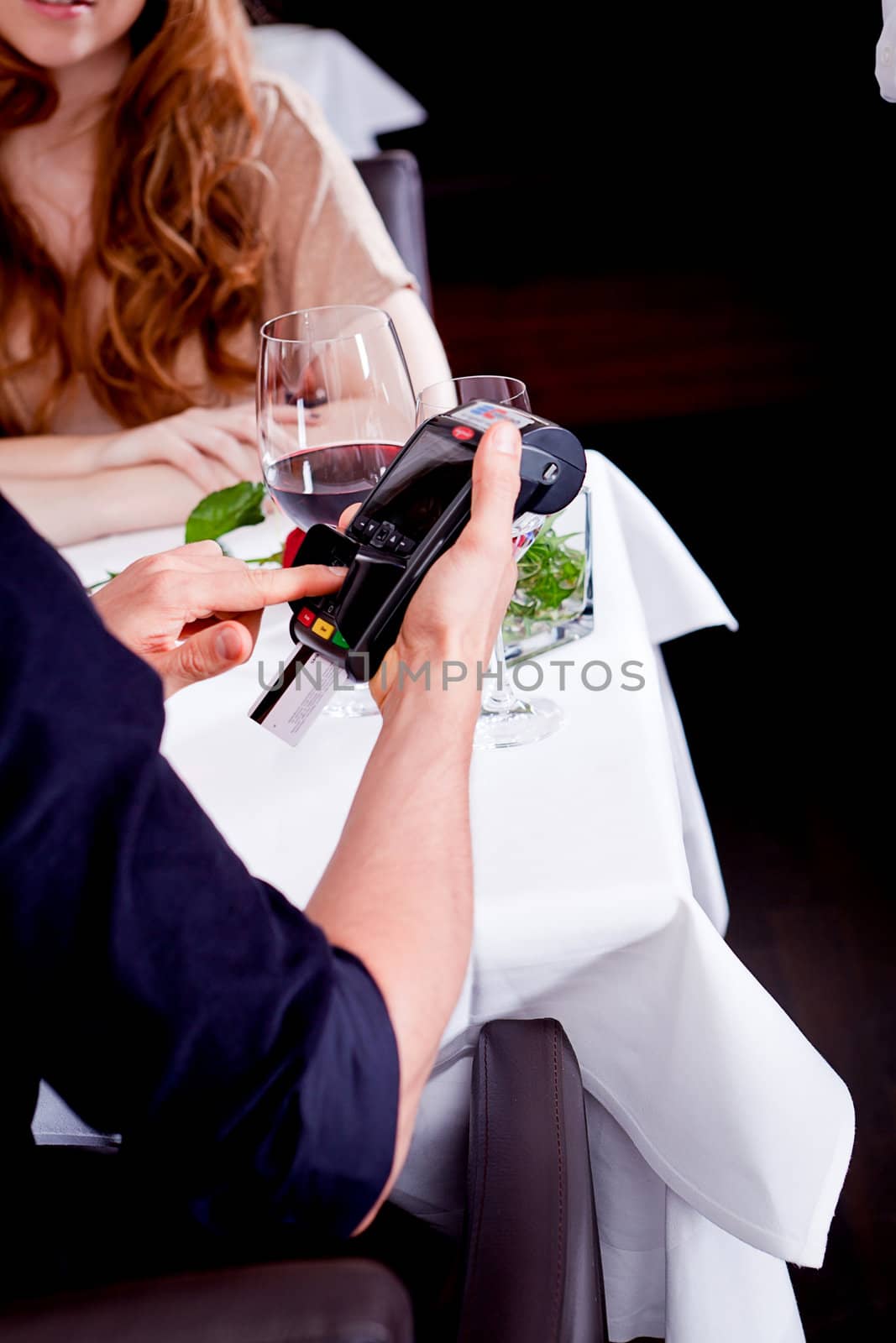 dinner in restaurant man and woman pay by credit card