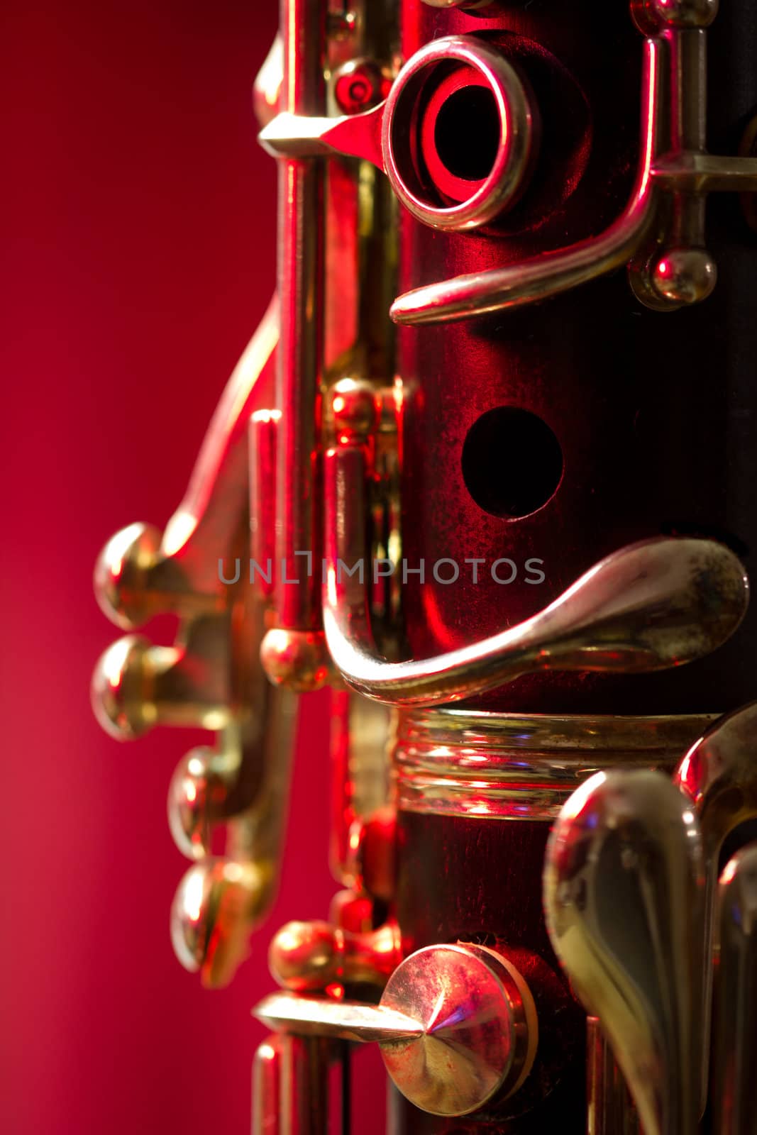 Close-up of a soprano clarinet on a red background