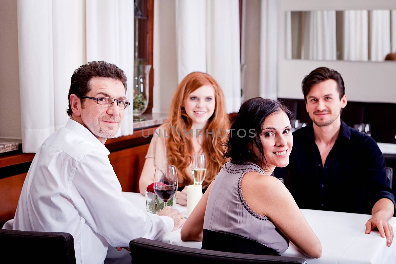 smiling happy people in restaurant drinking talking having fun 