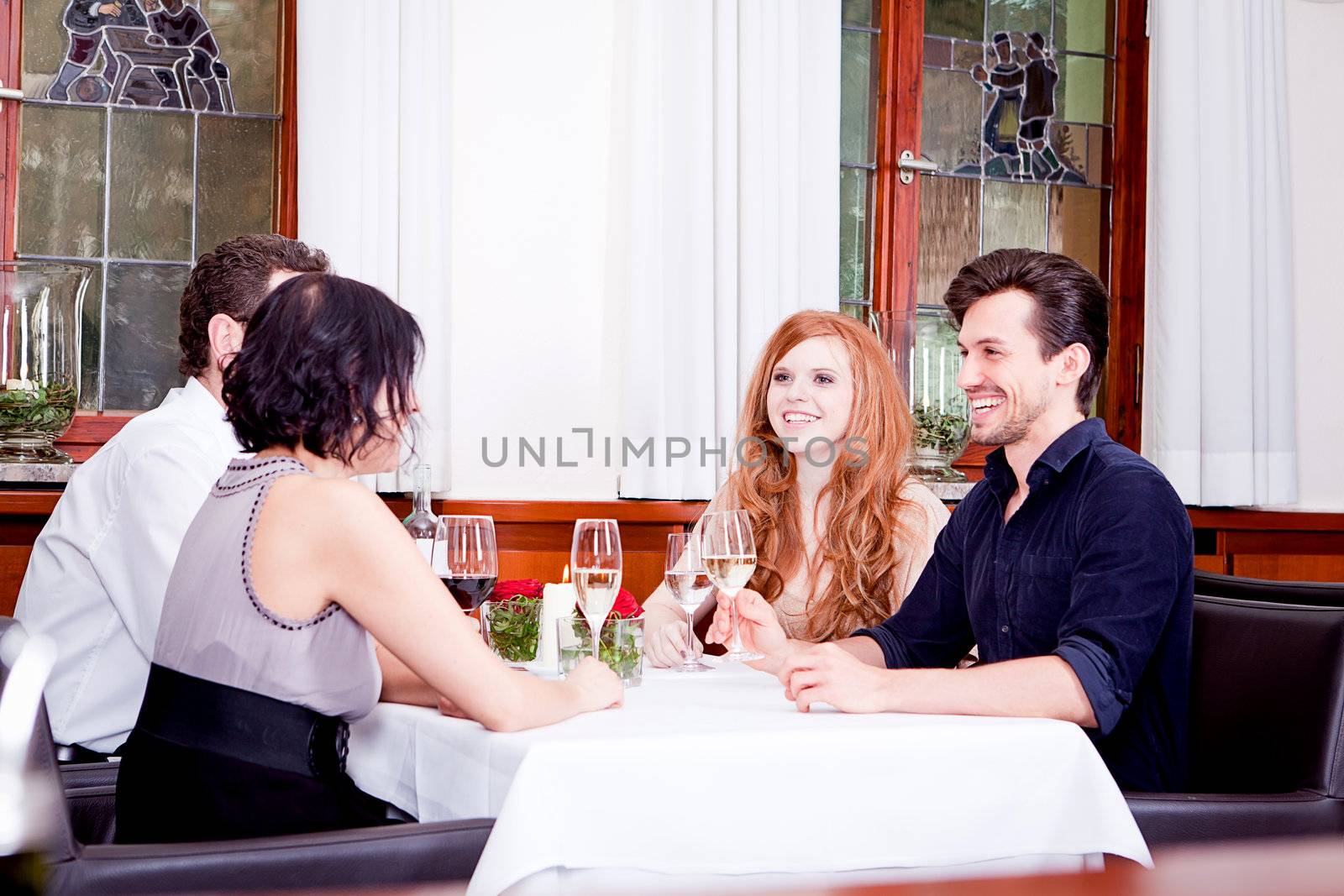 smiling happy people in restaurant drinking talking having fun 