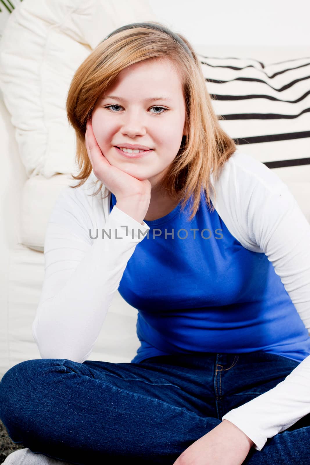 happy teenager girl smiling sitting on couch  by juniart