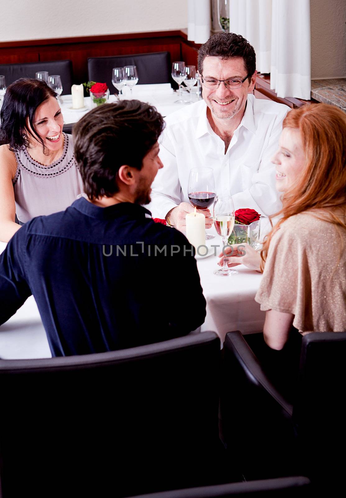 smiling happy people in restaurant drinking talking having fun 