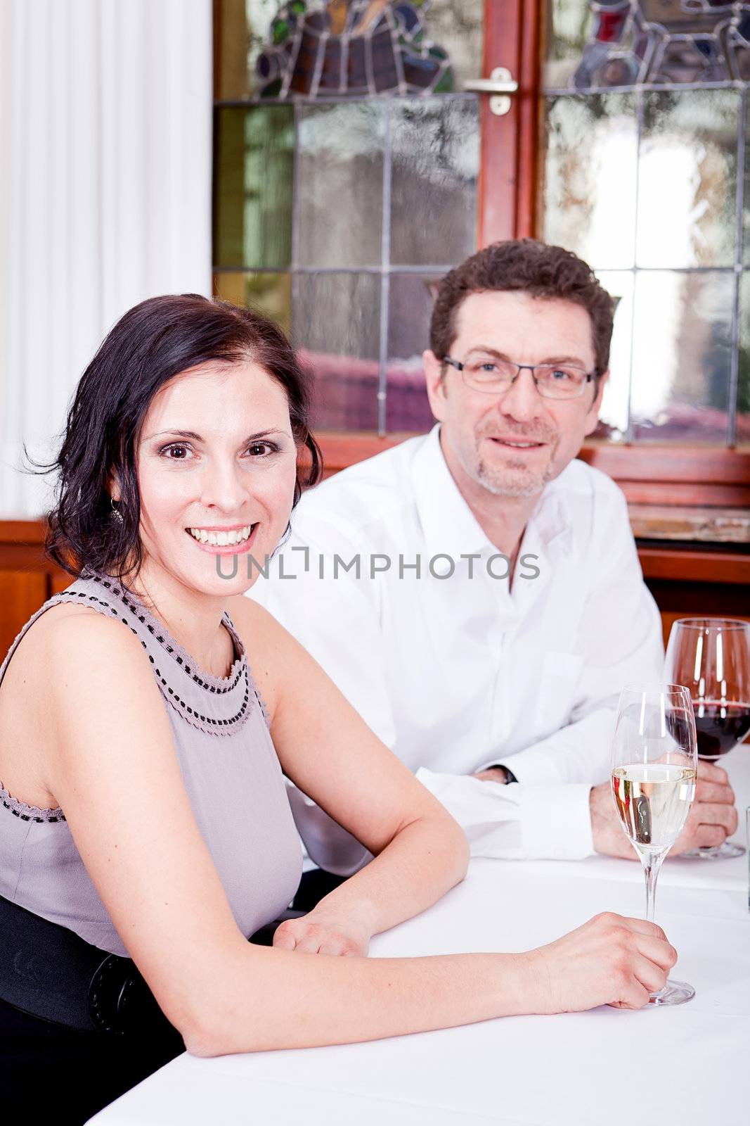 smiling happy people in restaurant drinking talking having fun 