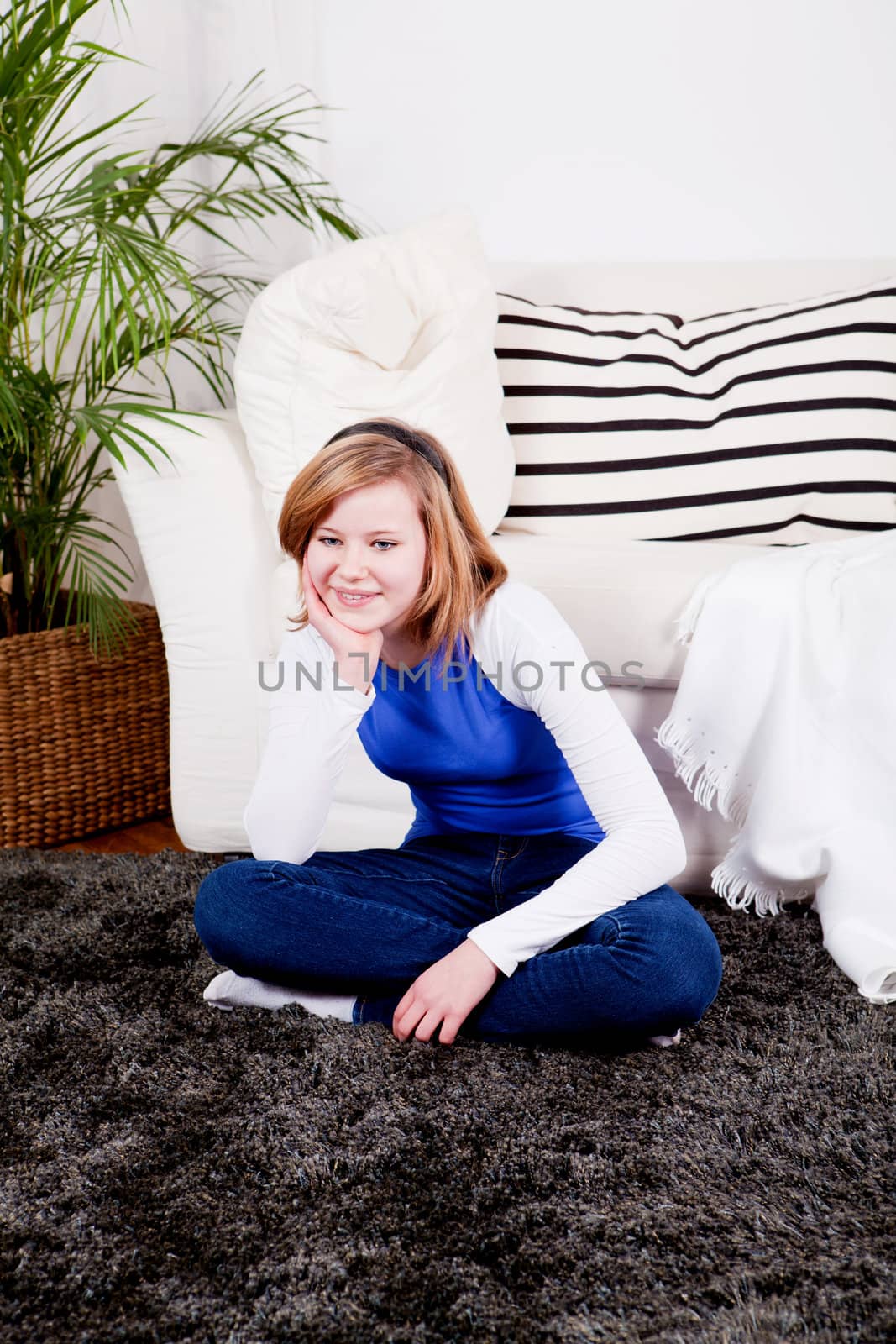 happy teenager girl smiling sitting on couch  by juniart