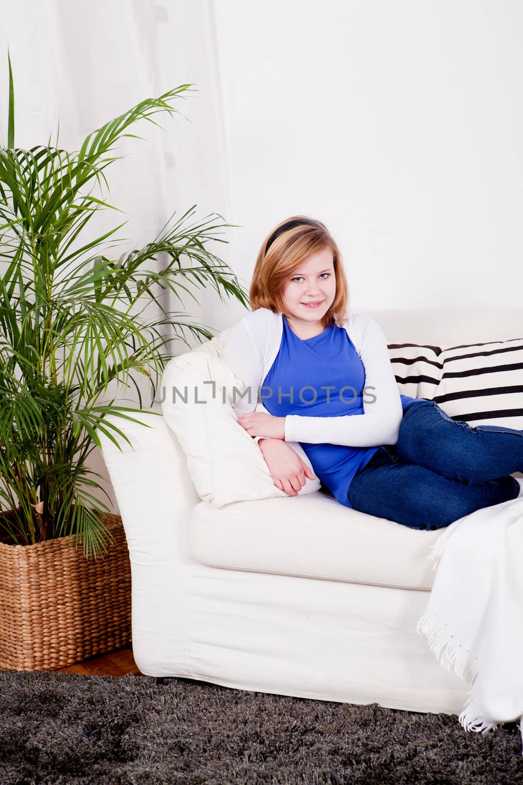 happy teenager girl smiling sitting on couch and relaxing lifestyle leisure