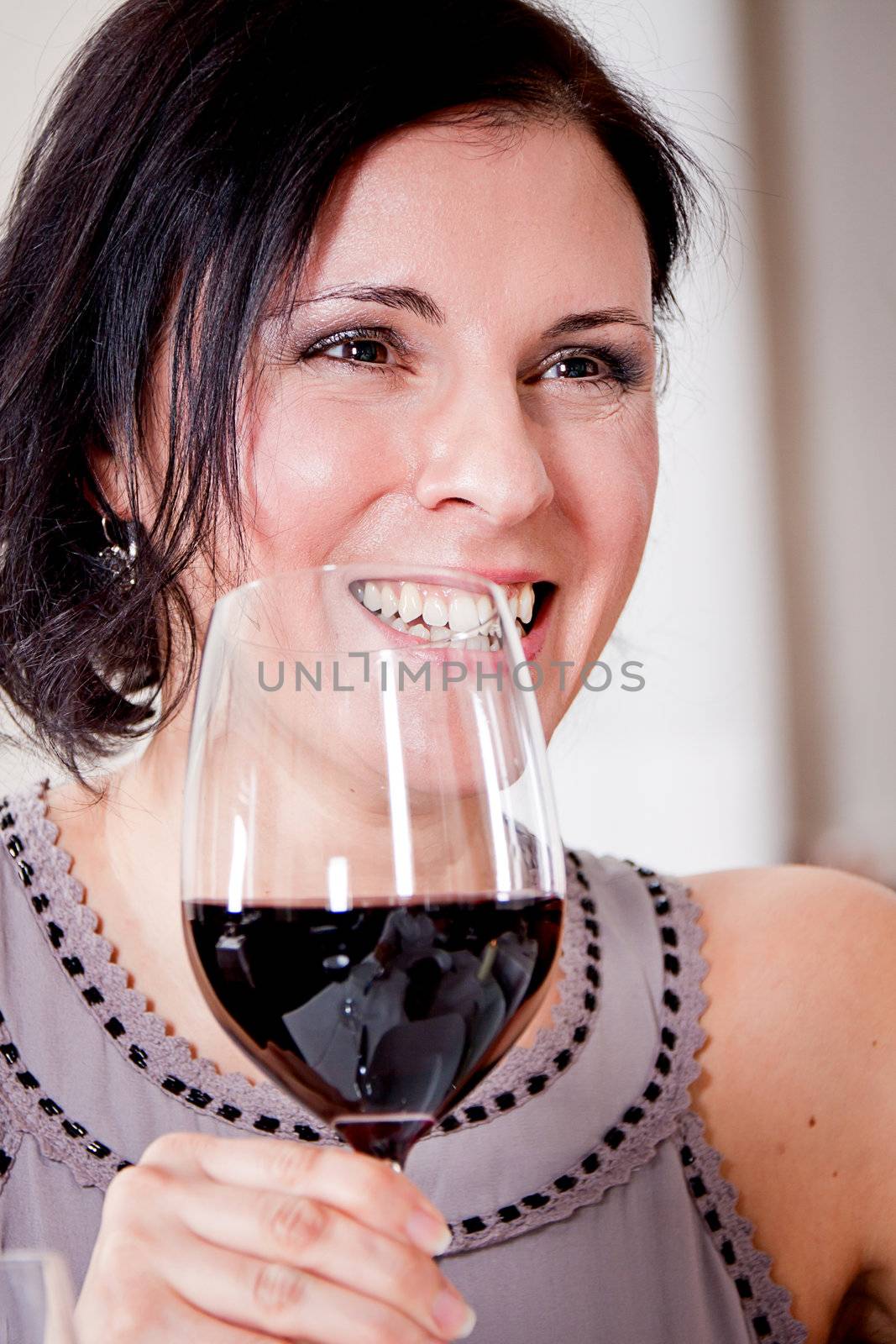 man and woman in restaurant for dinner drinking red wine and smiling