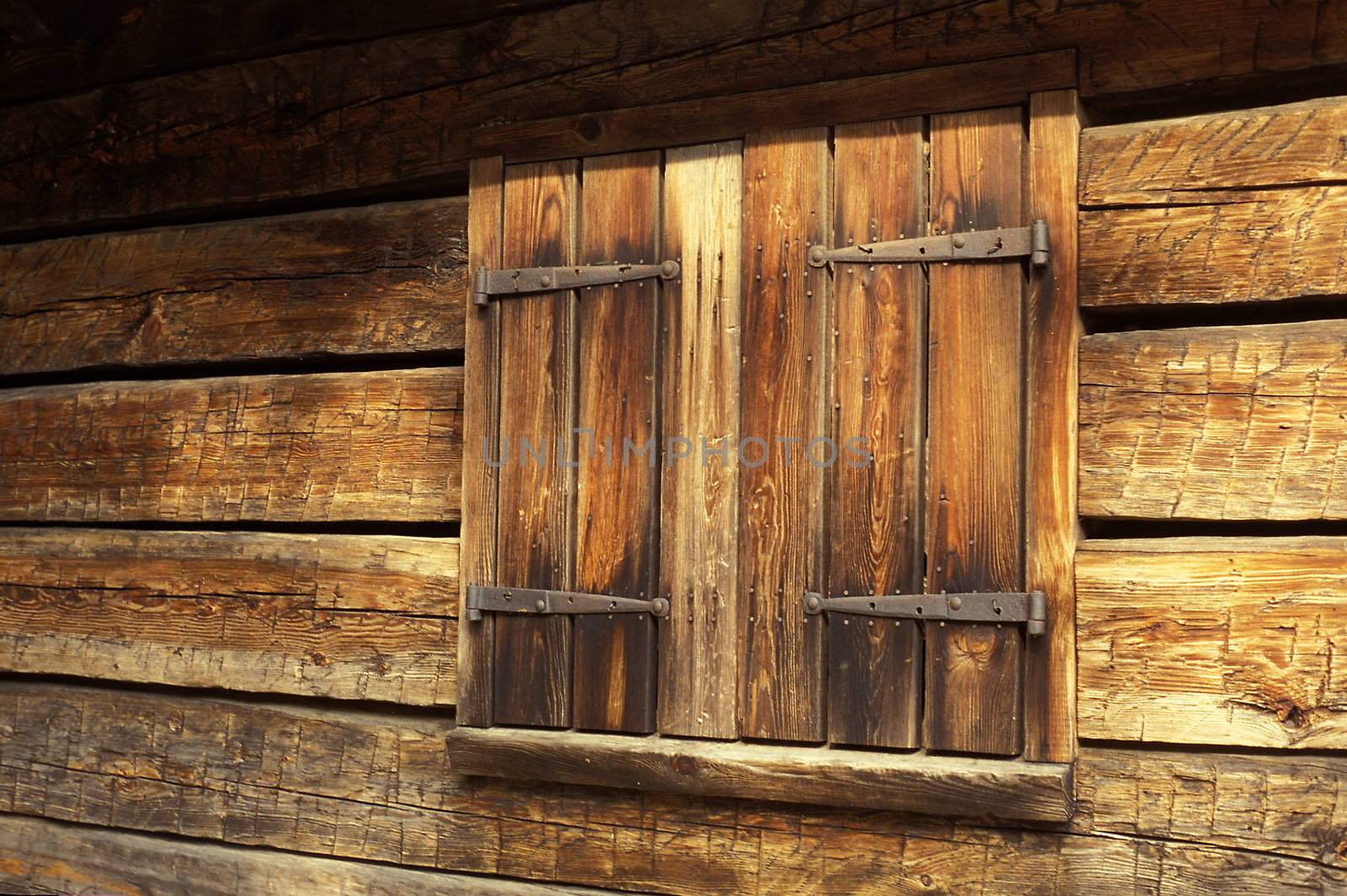 A shuttered window on an old barn