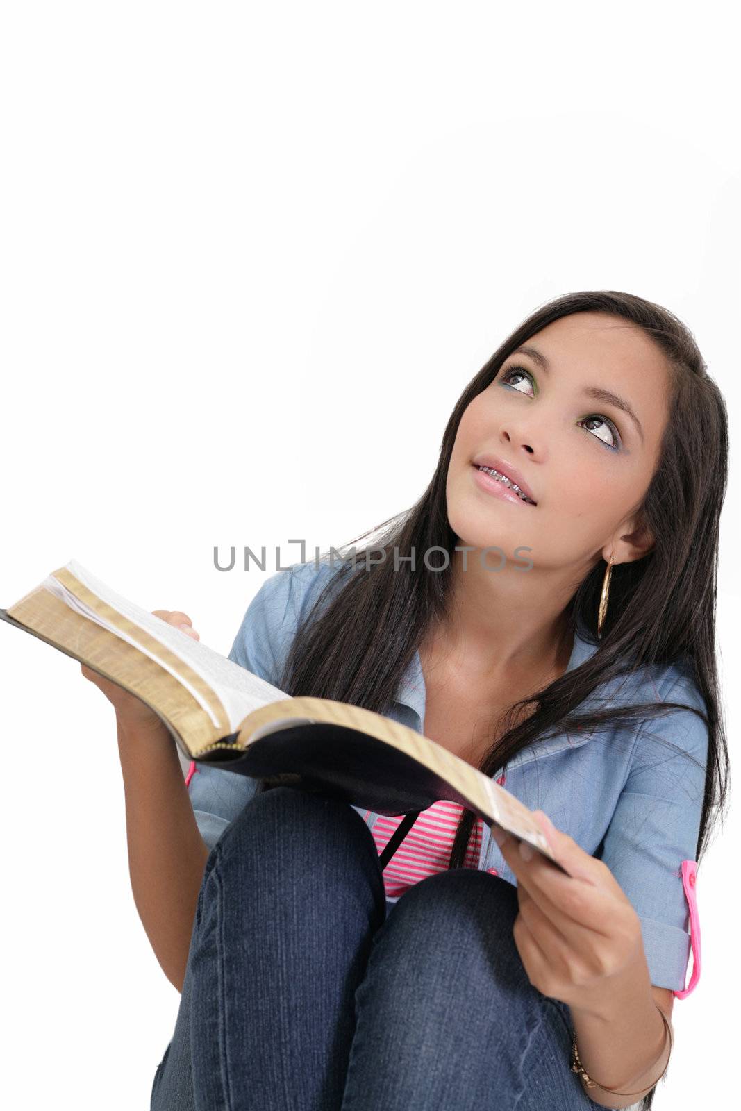 Beautiful young woman holding a Bible by dacasdo