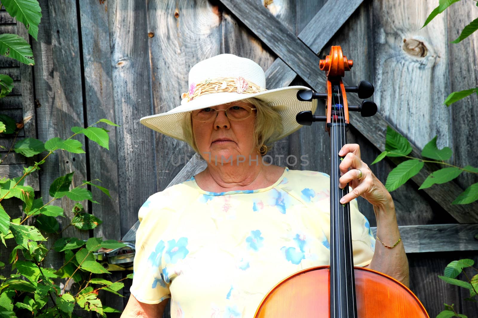 Female cellist with her cello outdoors.