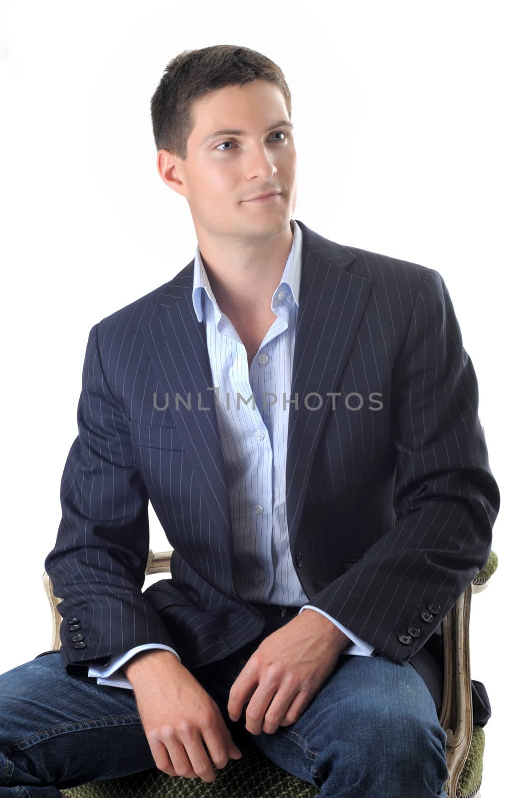 young business man in a chair on front of white background