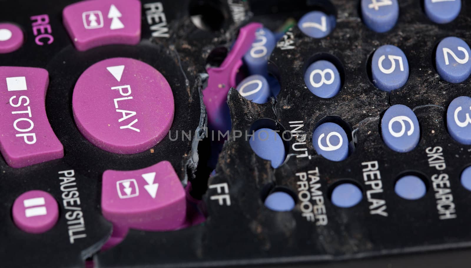 Broken remote control with focus on play button
