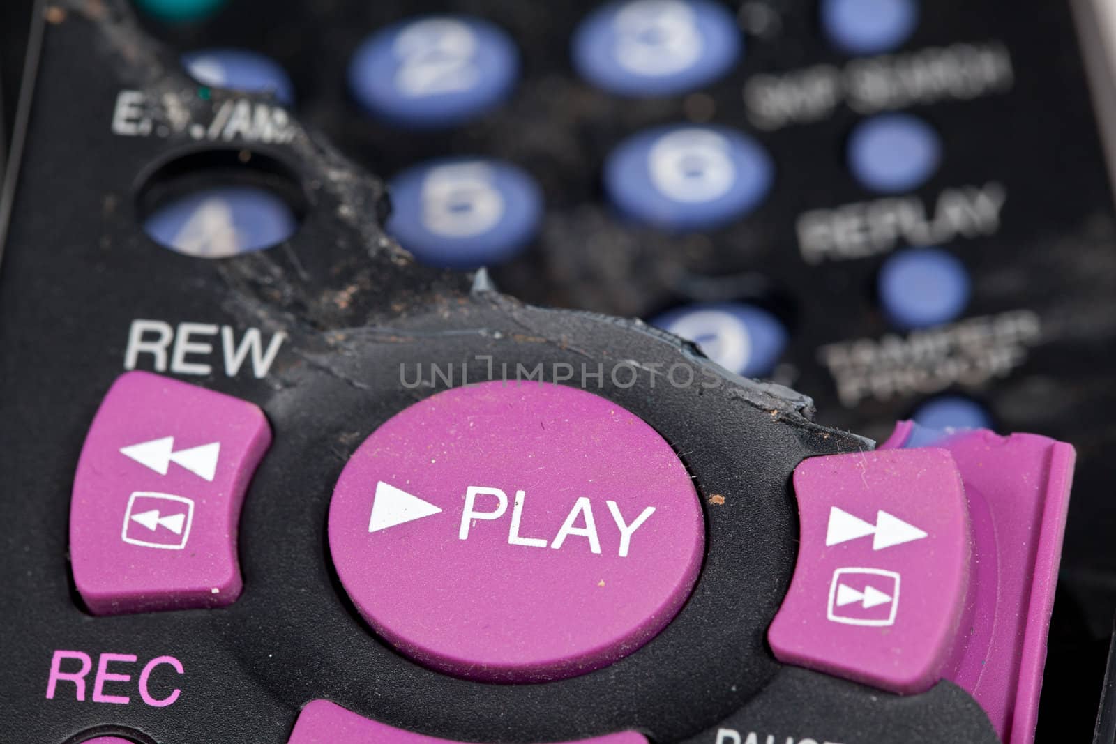 Broken remote control with focus on play button