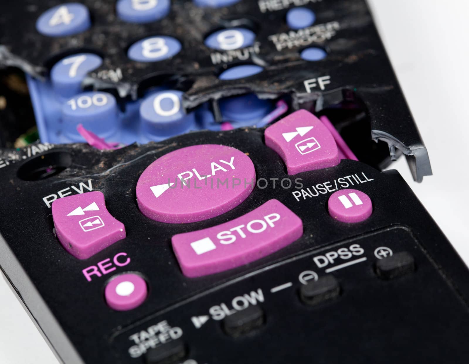 Broken remote control with focus on play button