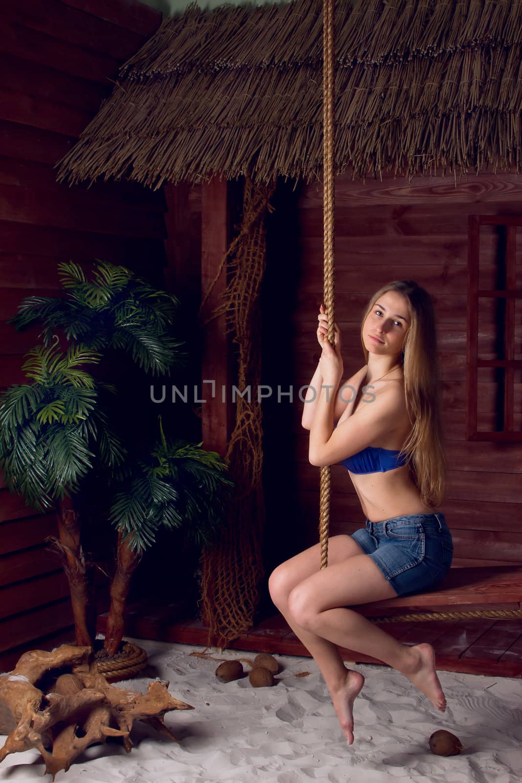 Girl playing on a swing-set on the beach