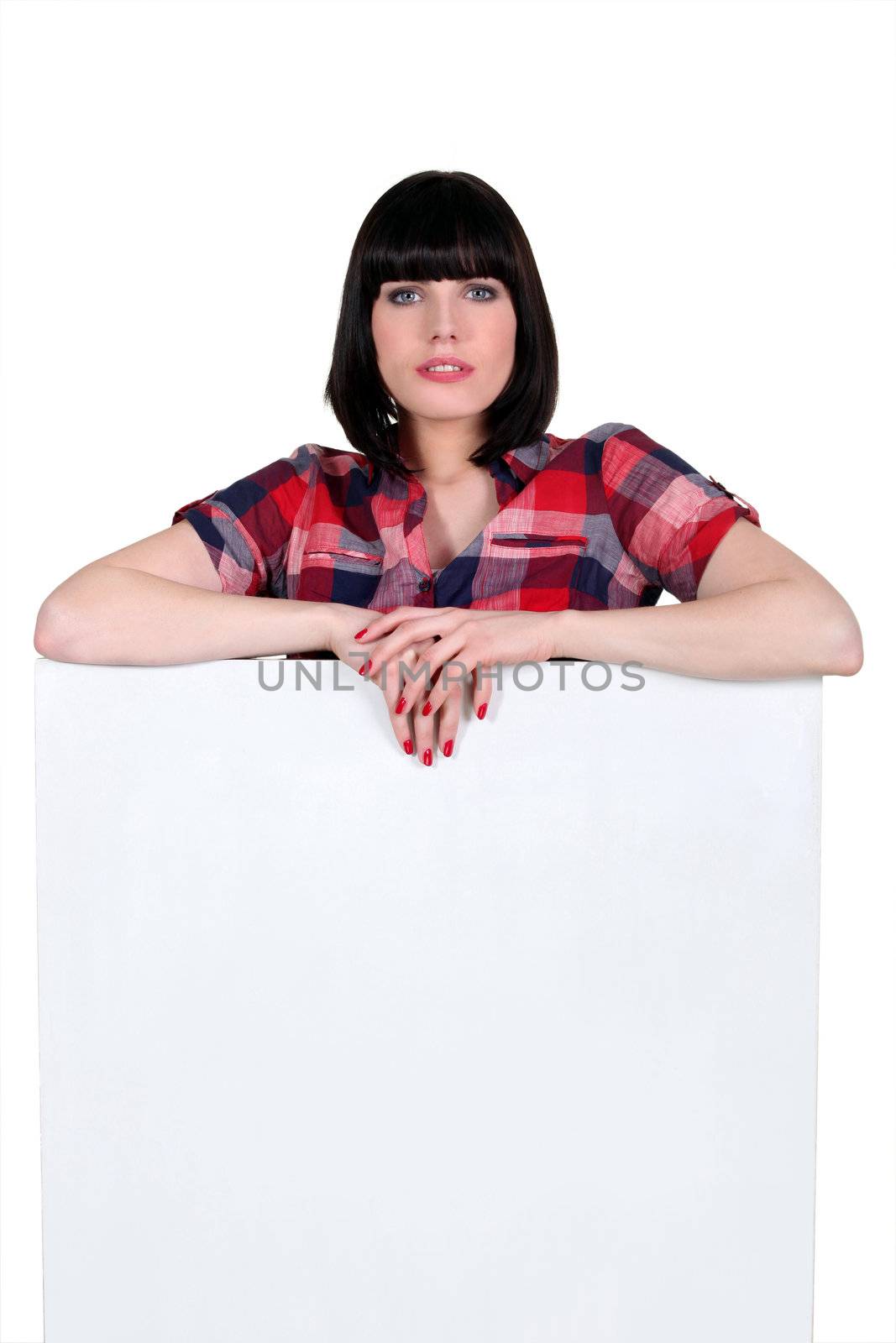 Brunette with a board left blank for your message by phovoir