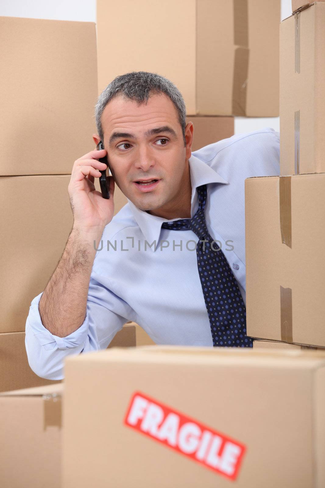 Cellphone user surrounded by boxes by phovoir