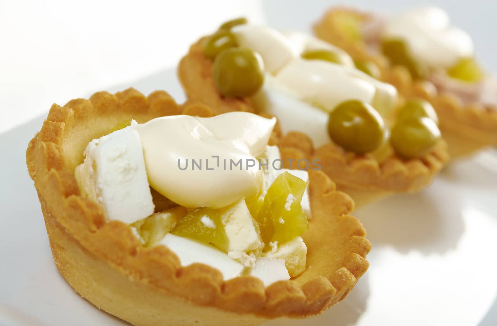tartlet with salad on a white plate .Shallow depth-of-field