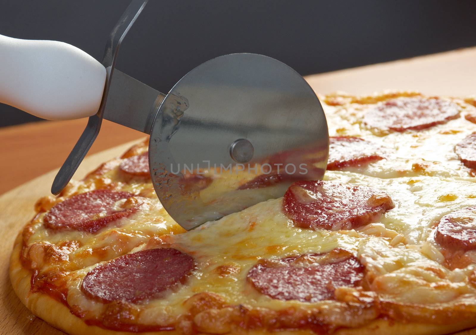 homemade pizza  Pepperoni.Closeup  a knife cut the pizza 