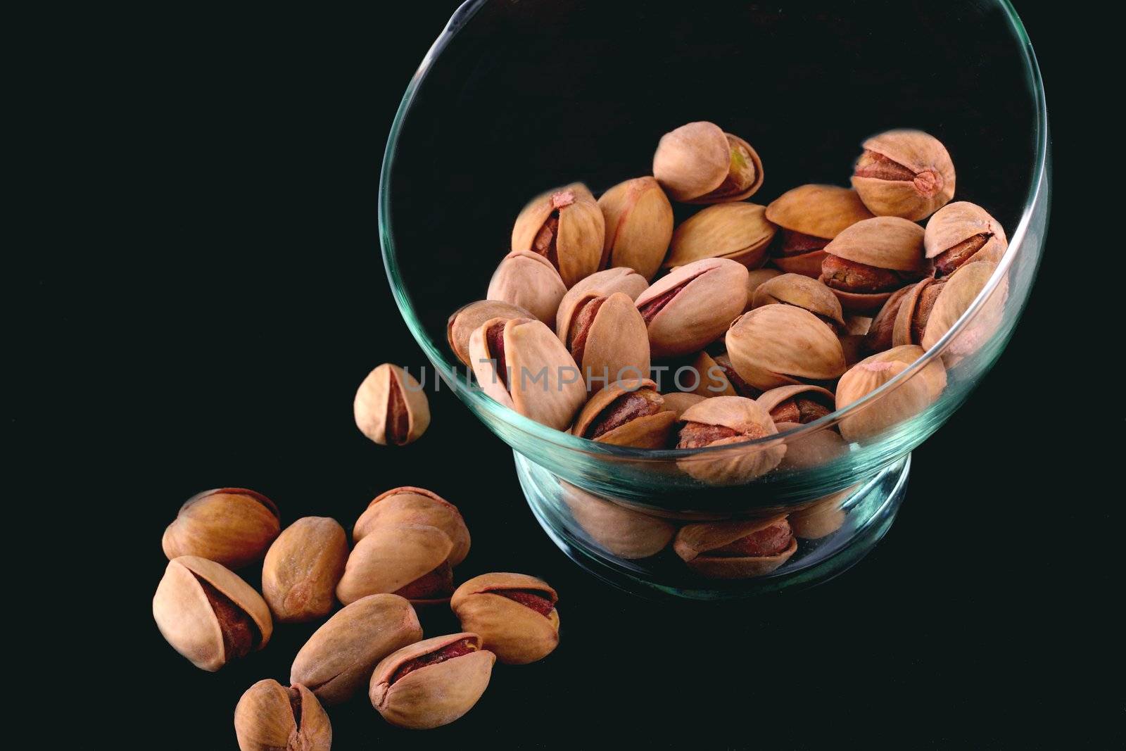 salted pistachios nut on a black background