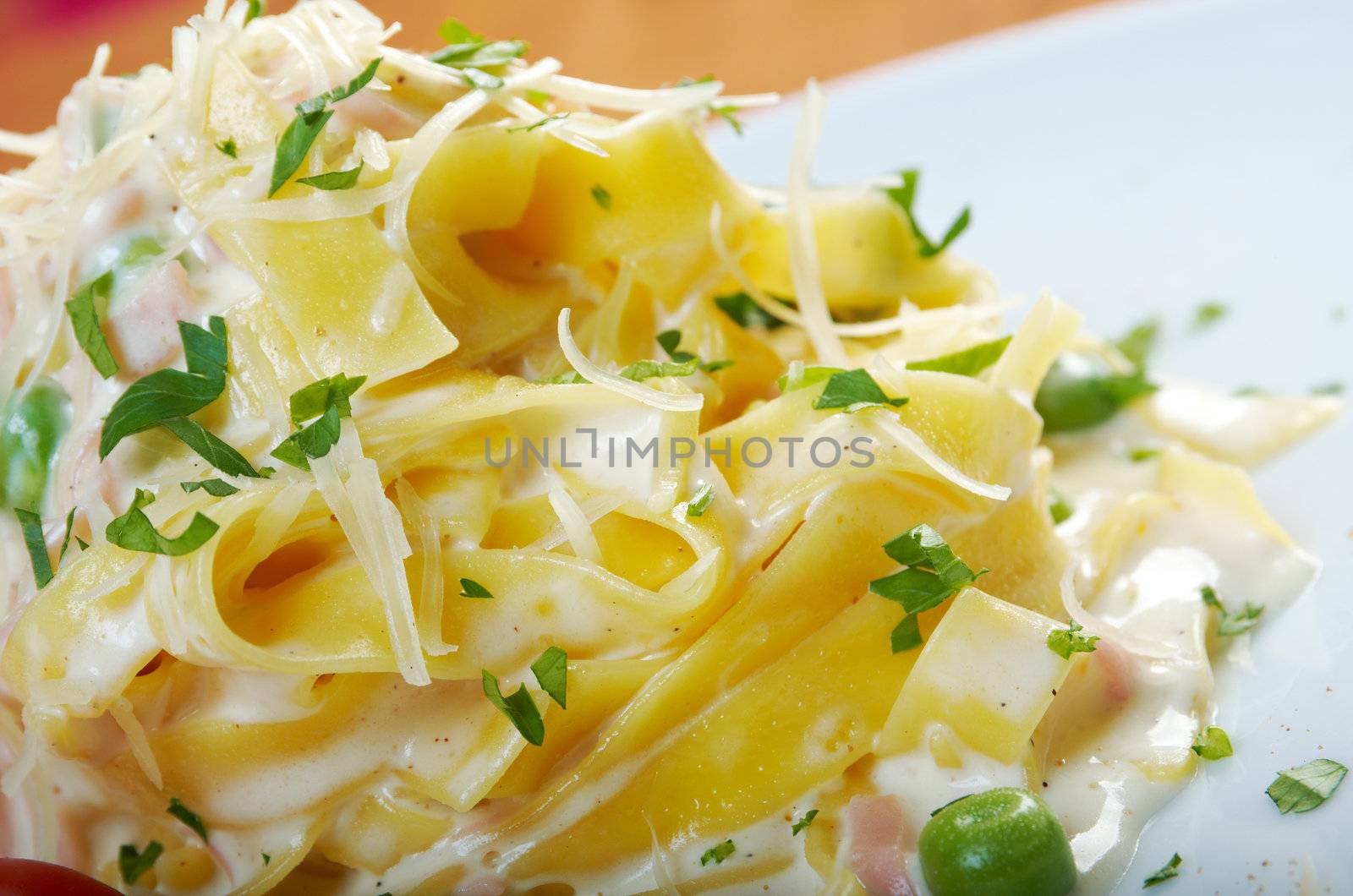 pasta Fettuccine Alfredo with cherry tomato, ham. close-up