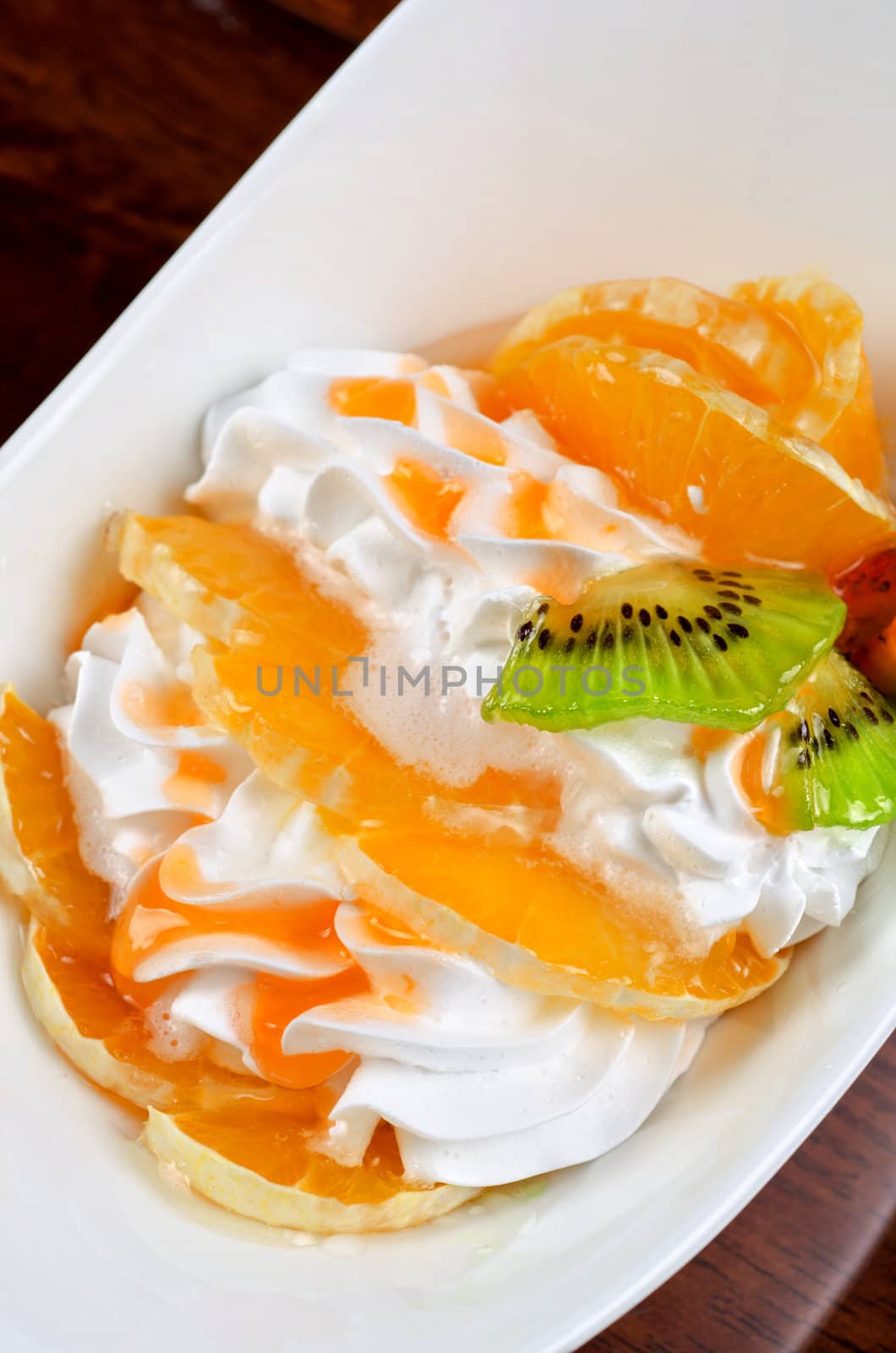 Ice cream dessert with kiwi, strawberry and orange