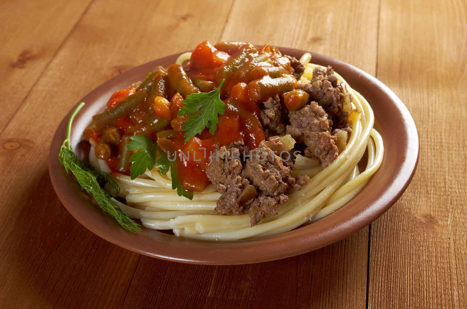  pasta with  beef ,vegetable  tomato sauce  on wooden table