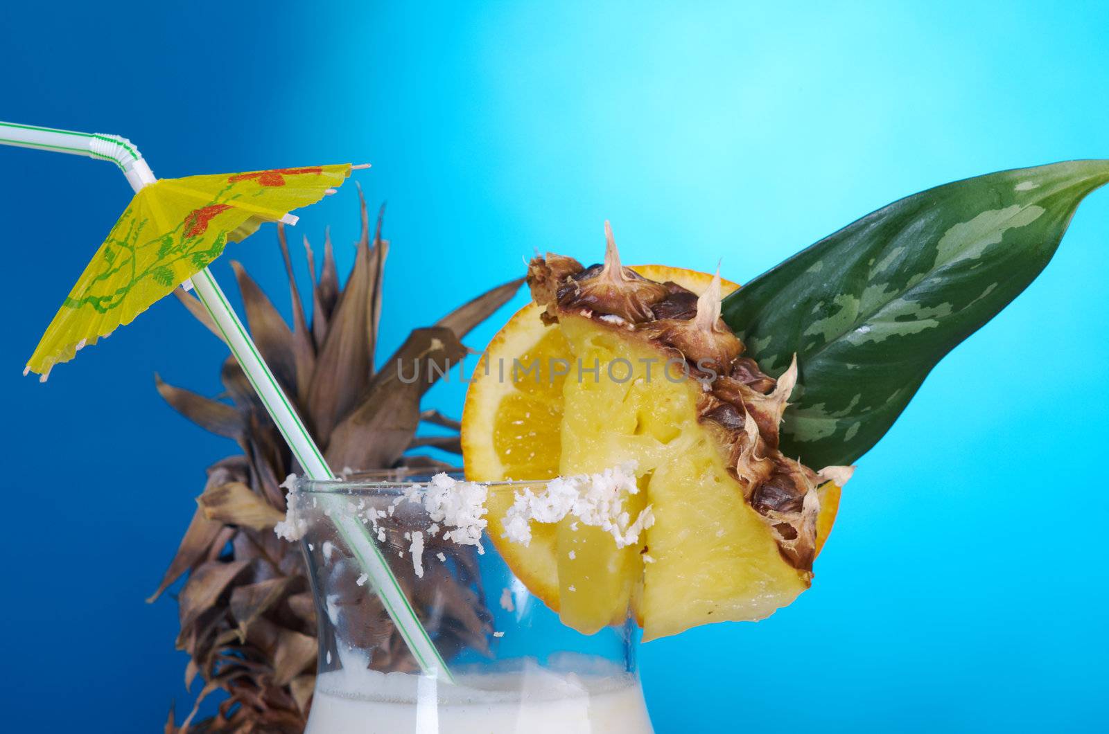 Pina Colada - Cocktail with Cream, Pineapple Juice and Rum on blue background