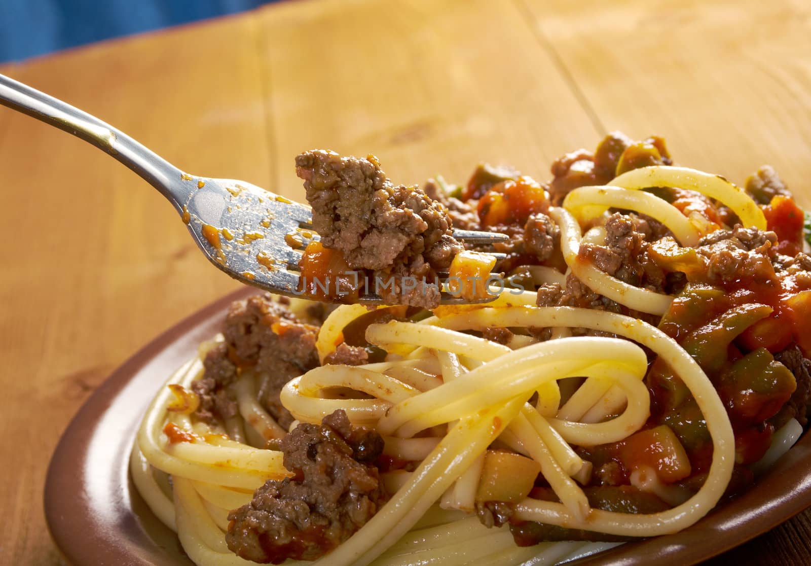  pasta with  beef ,vegetable  tomato sauce  on wooden table