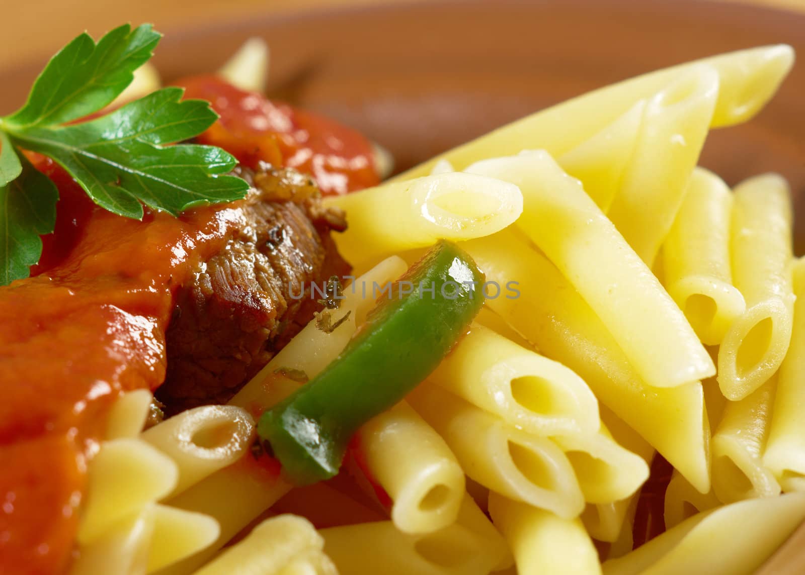  pasta with tomato beef sauce  on wooden table