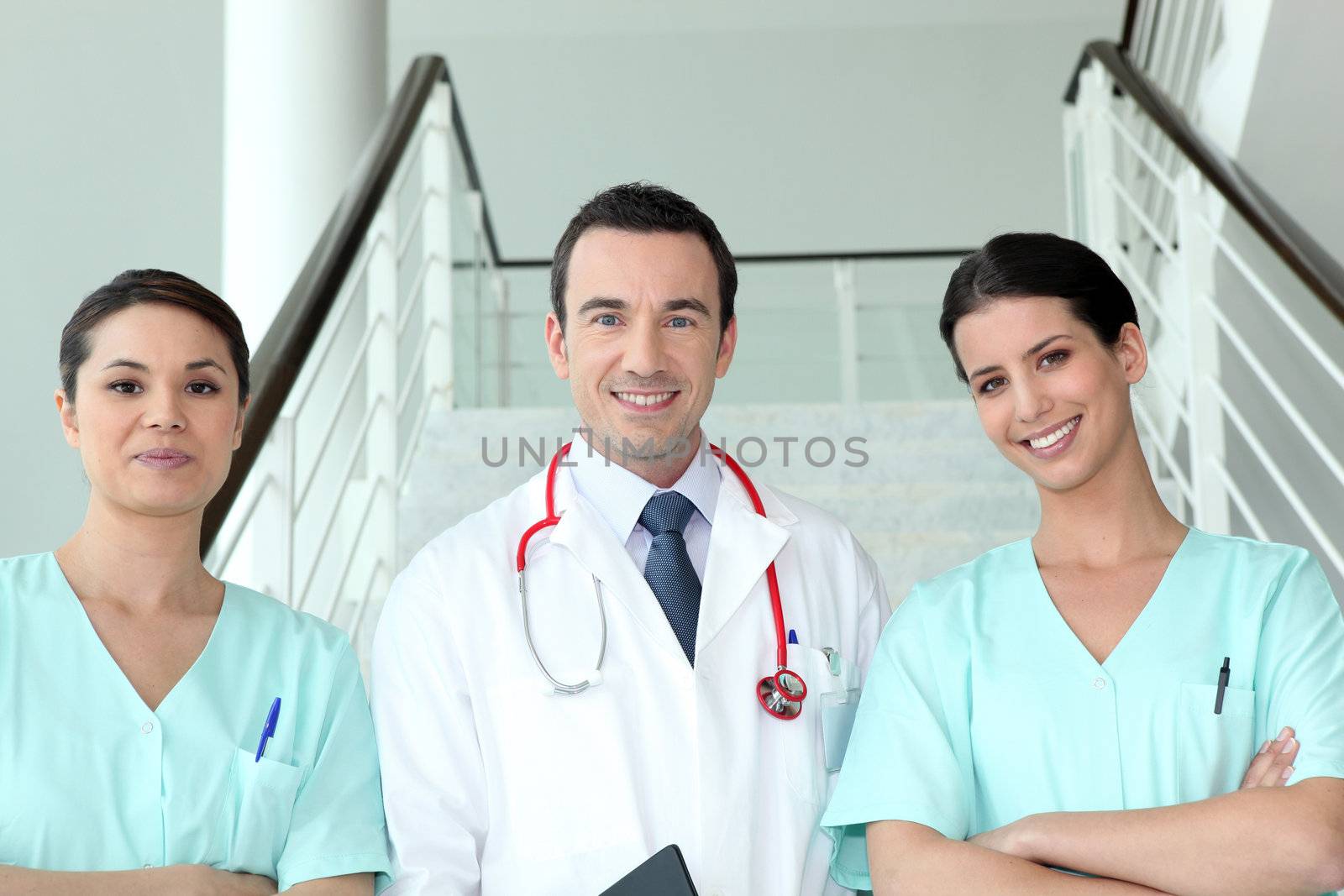 Portrait of two female nurses with doctor by phovoir