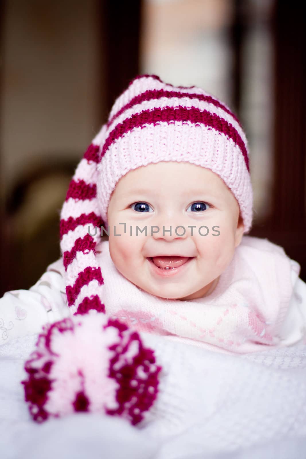 cute baby in a striped hat with pompom