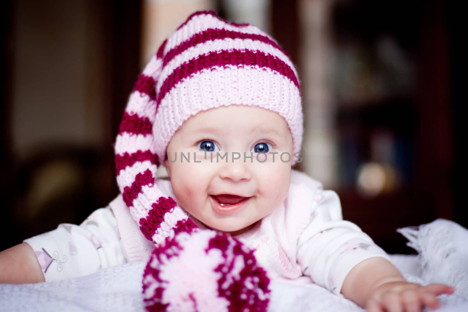 cute baby in a striped purple hat with pompom