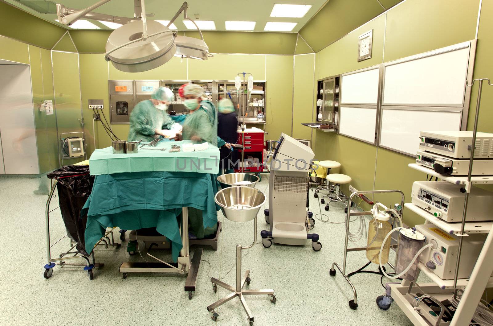 Blurred figures of doctors performing surgery in operative room
