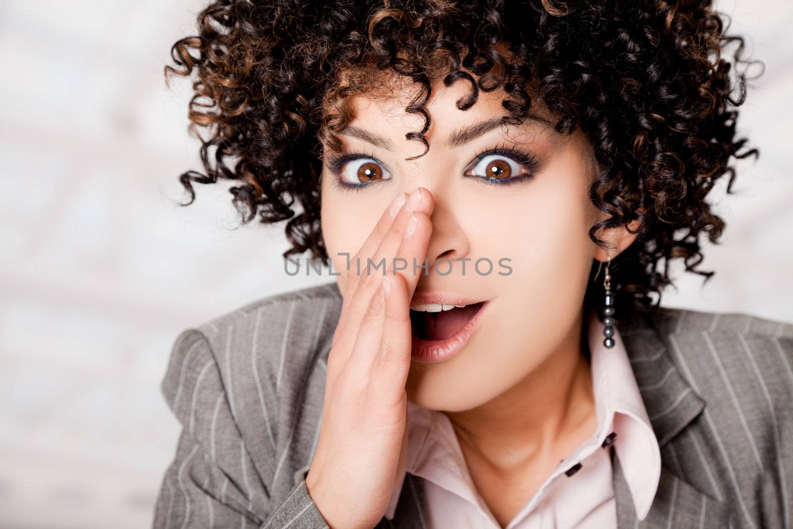 Beautiful woman with curly hair telling a secret