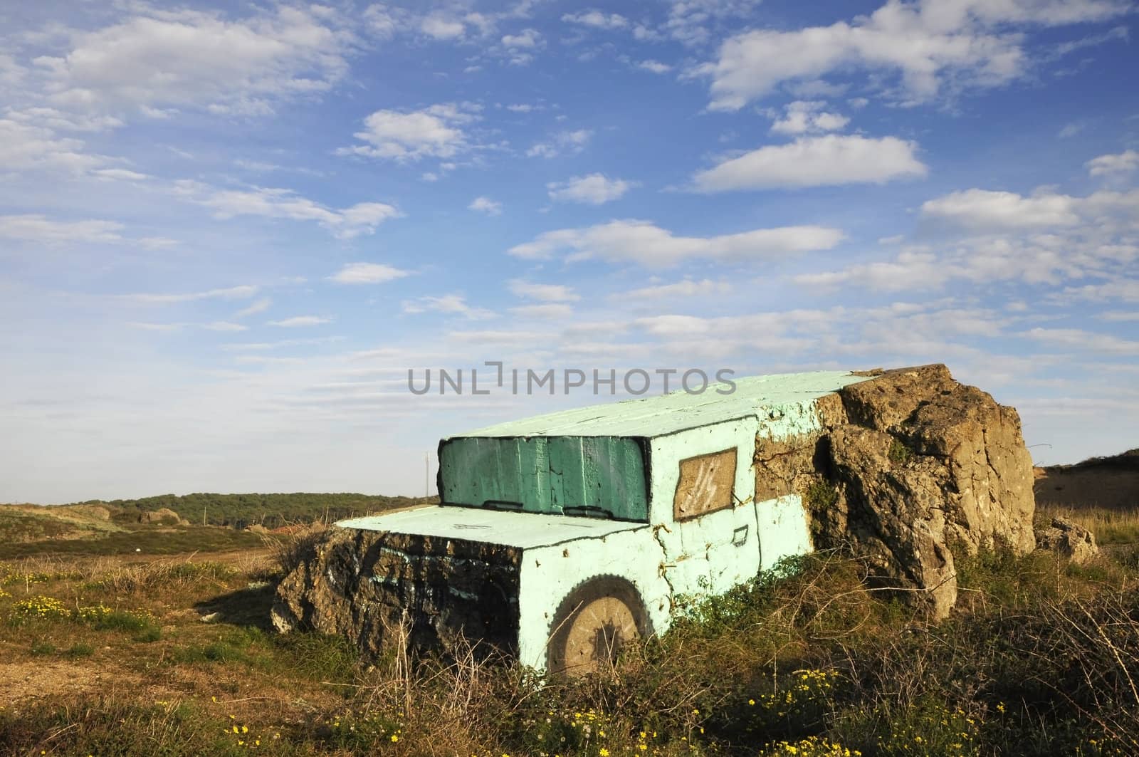 Drawn and sculpted rocks in dunes with a blue sky