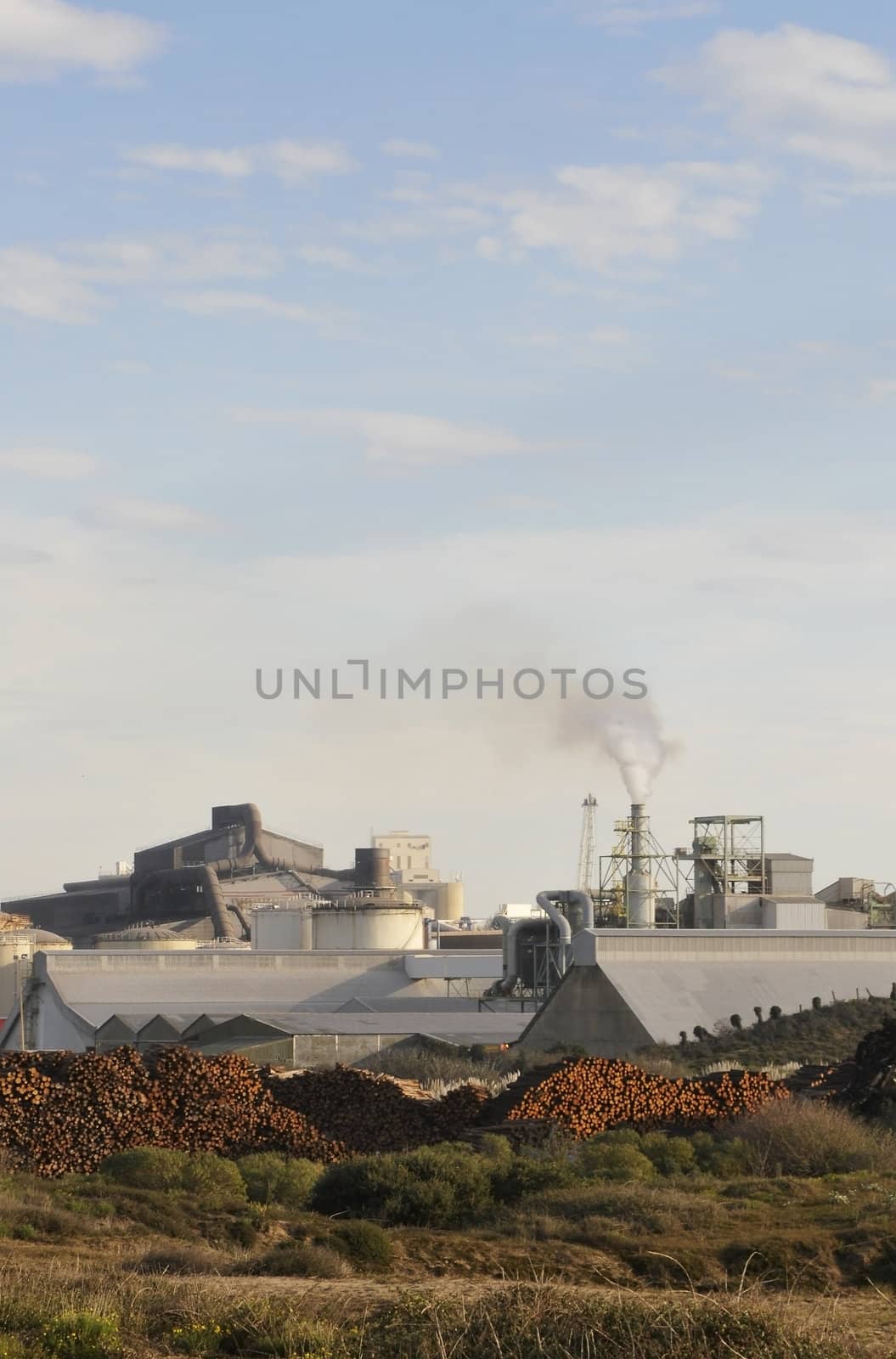 Industrial site in dunes with a blue sky