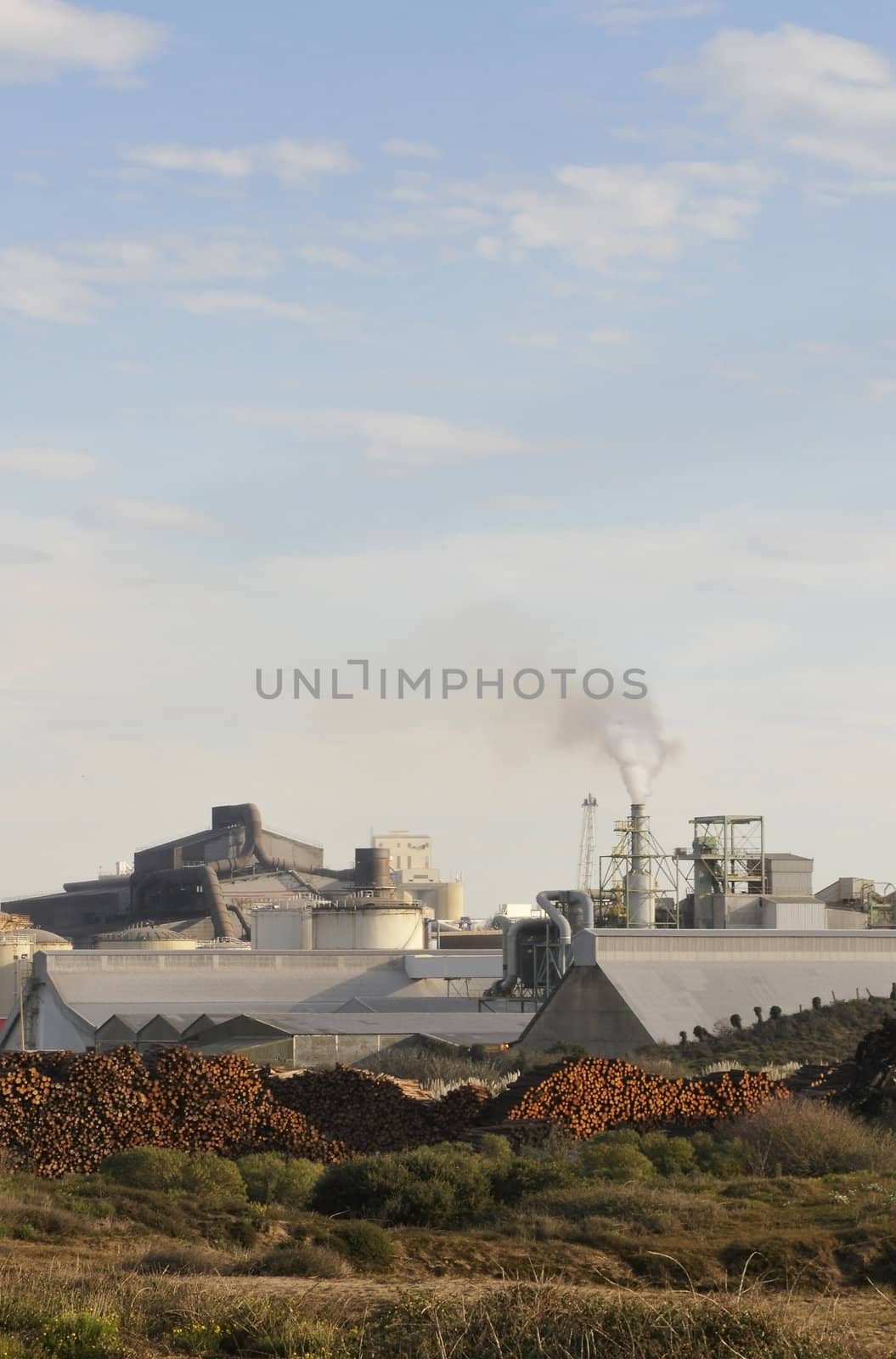 Industrial site in dunes with a blue sky