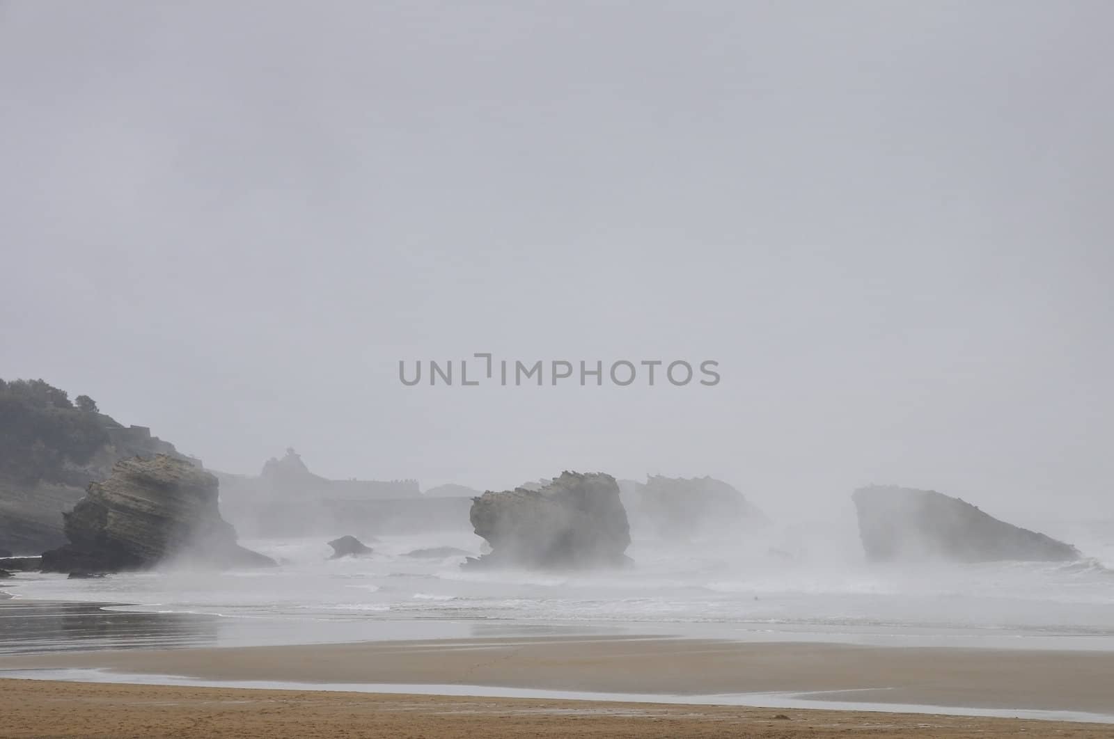 Rocks and beach under the rain into the mist by shkyo30