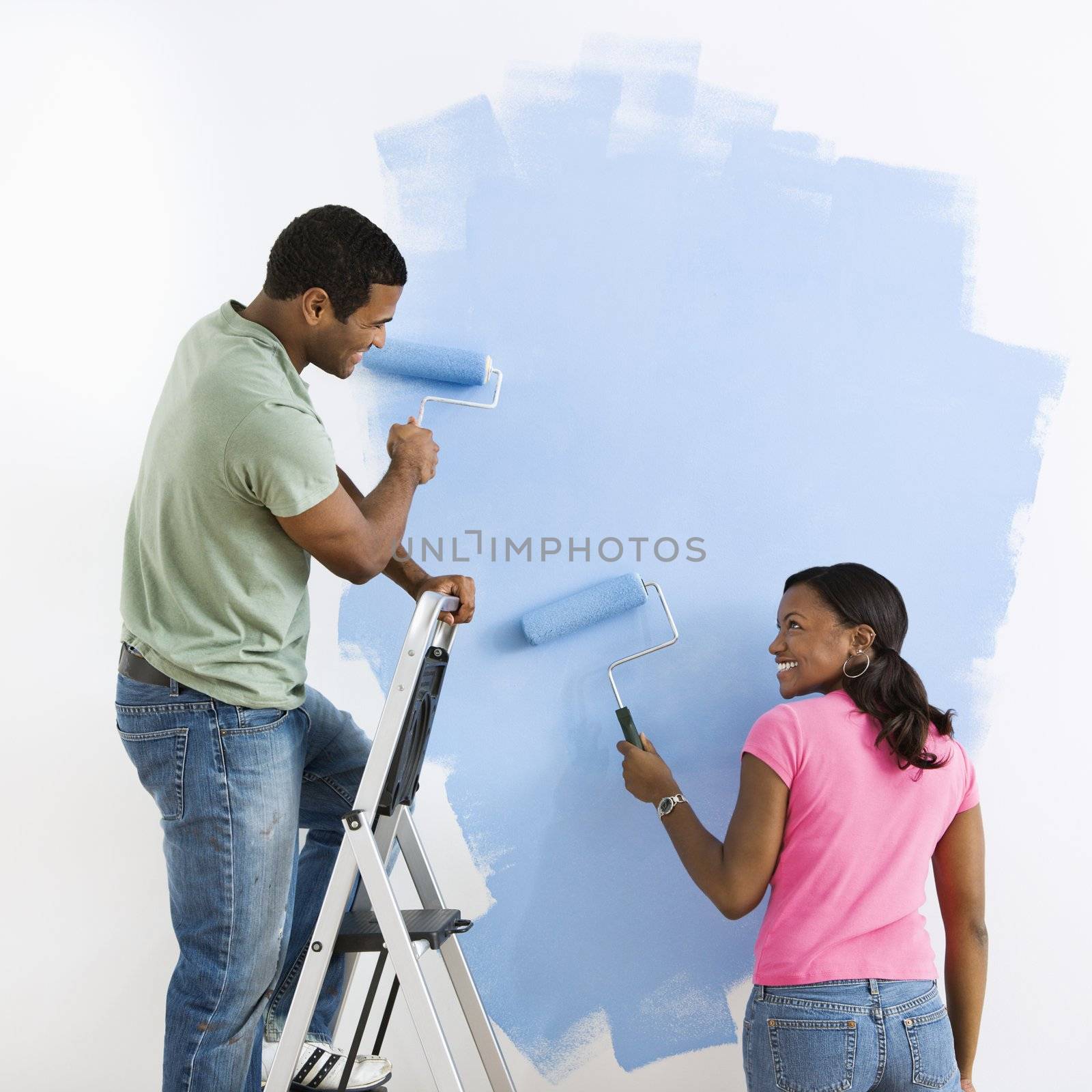 Couple painting together. by iofoto